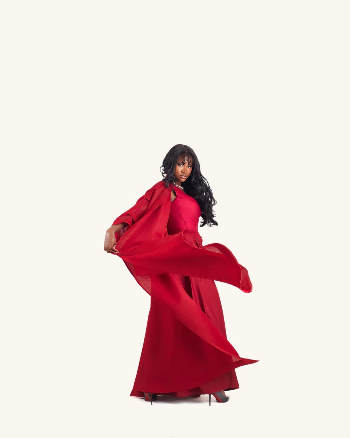 Model in red cape, fabric flowing